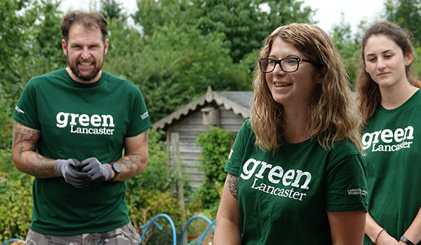 Volunteers working outdoors wearing Green СʪƵ t-shirts